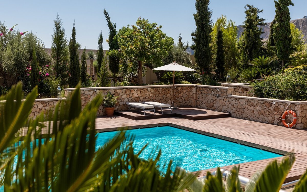 A pool and loungers at a Mediterranean villa