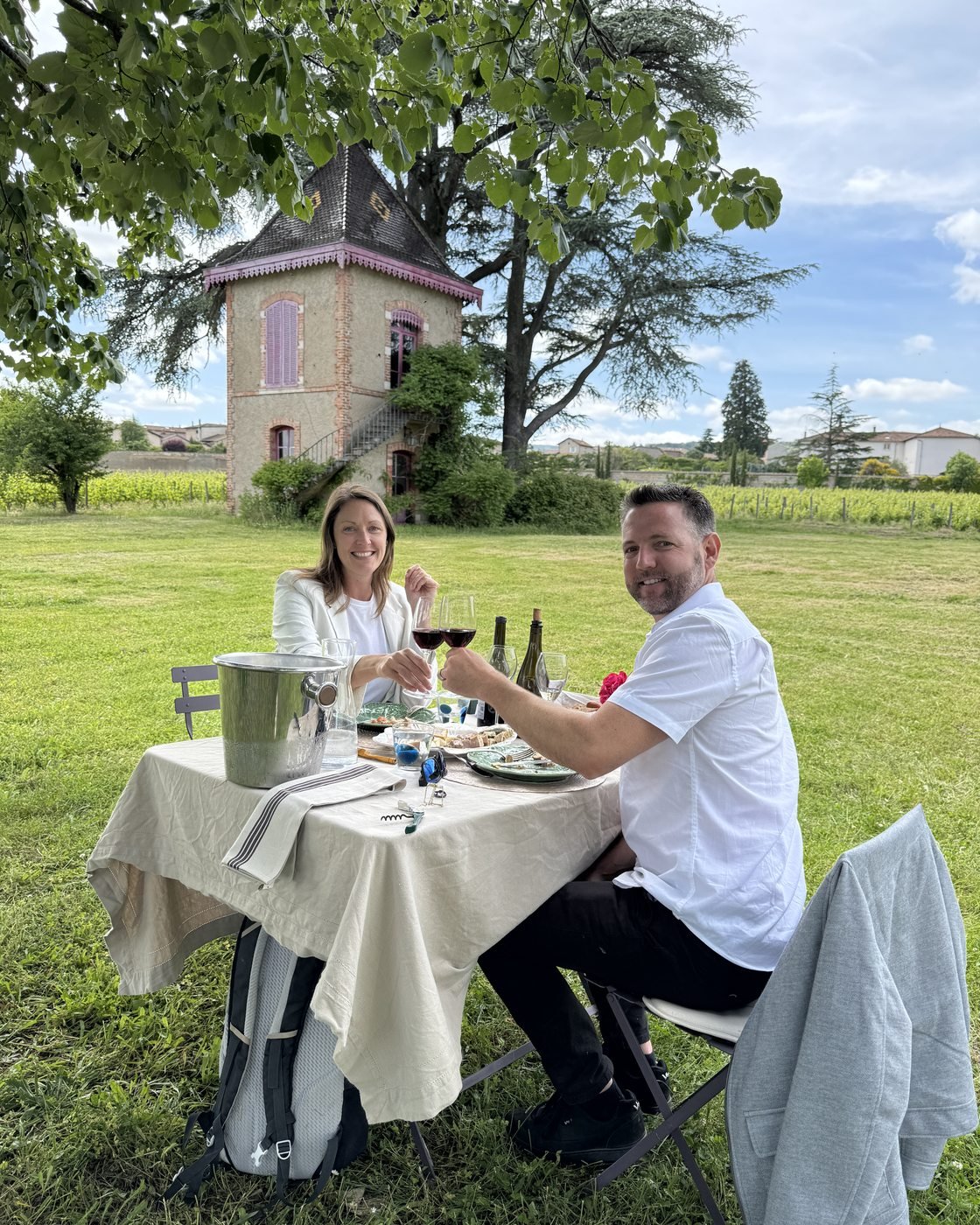 Dariece and Nick toasting with wine at the estate in Beaujolais