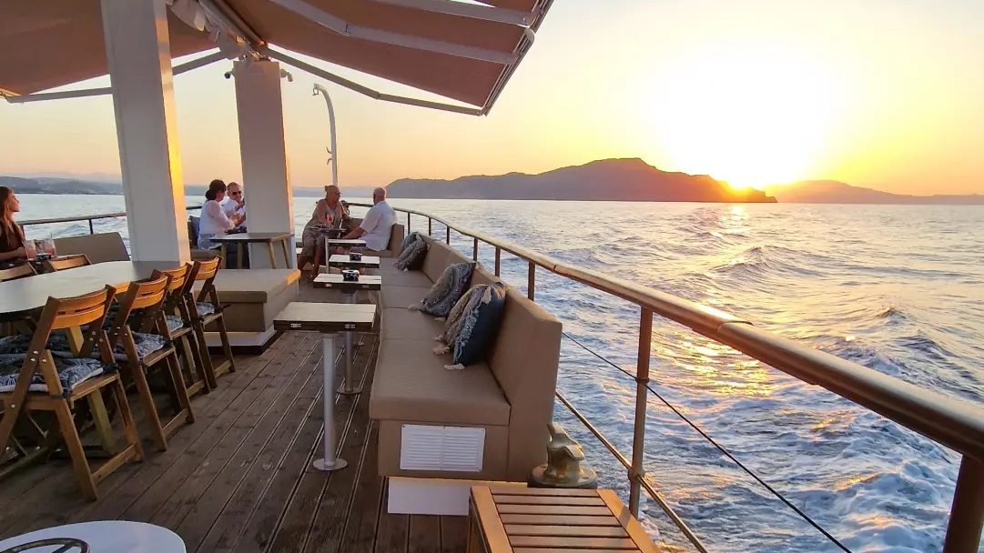 Deck loungers as the sun sets over the sea