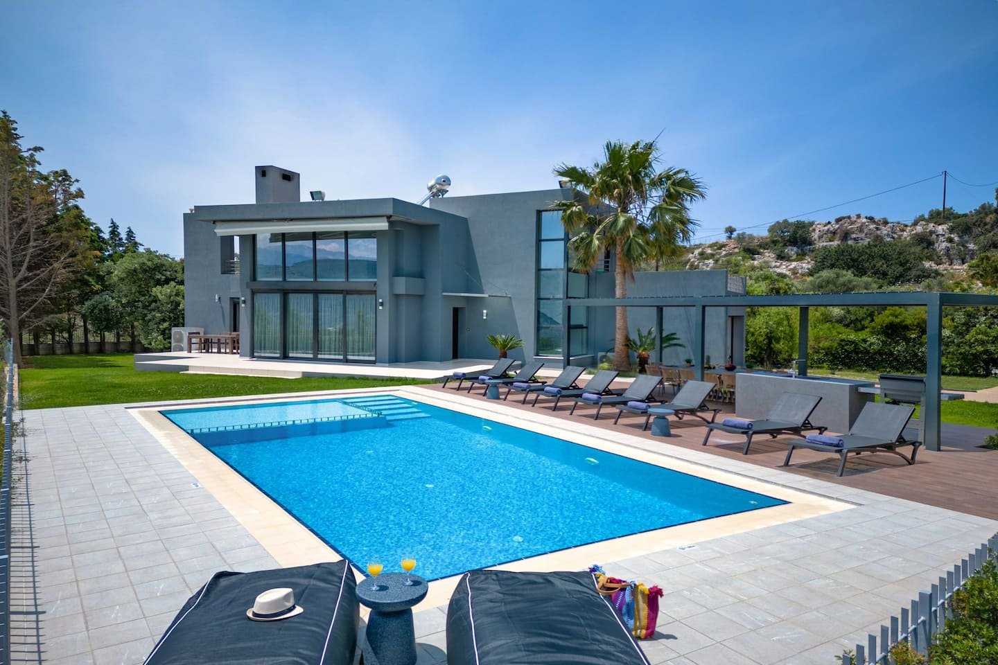 The villa pool and terrace in the afternoon sun